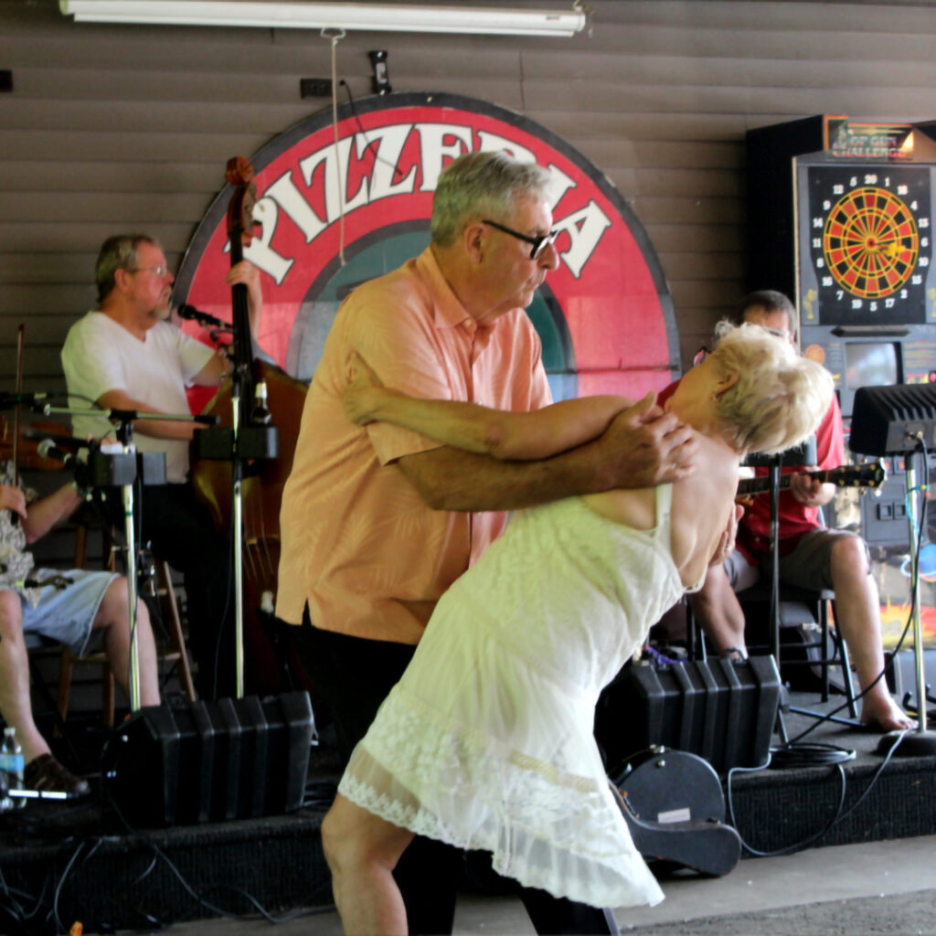 A graphic of a man and woman dancing to a band at the Back Bar