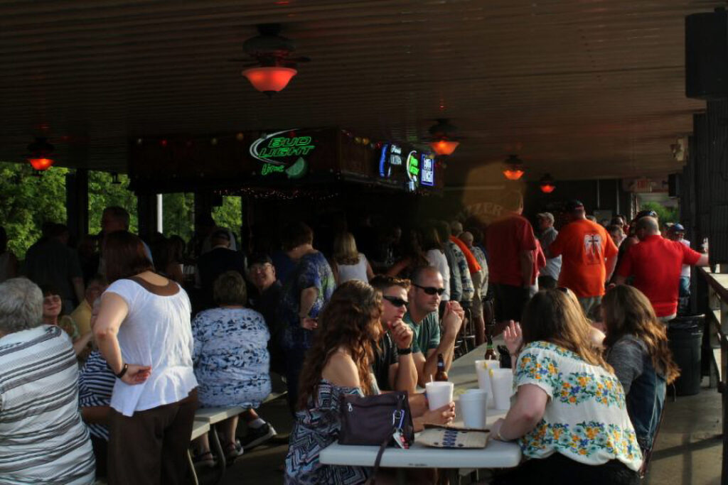 A graphic of guests sitting at the bar and picnic tables at the Back Bar