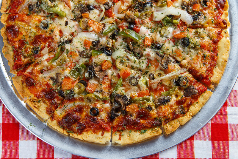 A graphic of a thin crust veggie pizza