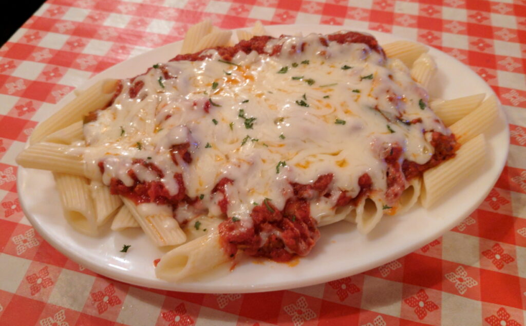 Mostaccioli topped with mozzarella cheese graphic