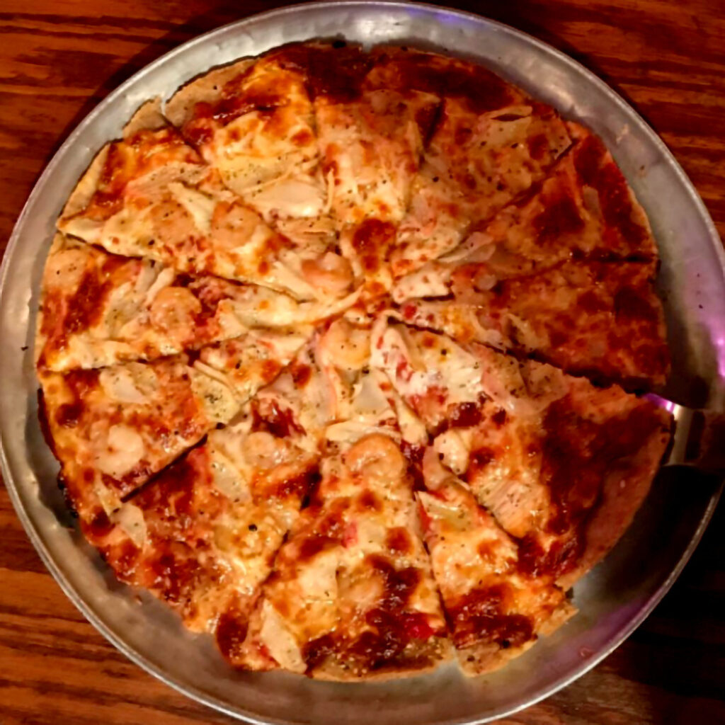 A graphic of a skinny pizza with a shrimp topping.